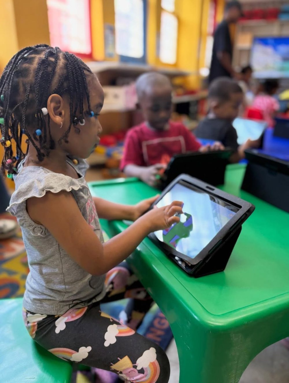 Young learners using tablets in an Afrika Tikkun classroom