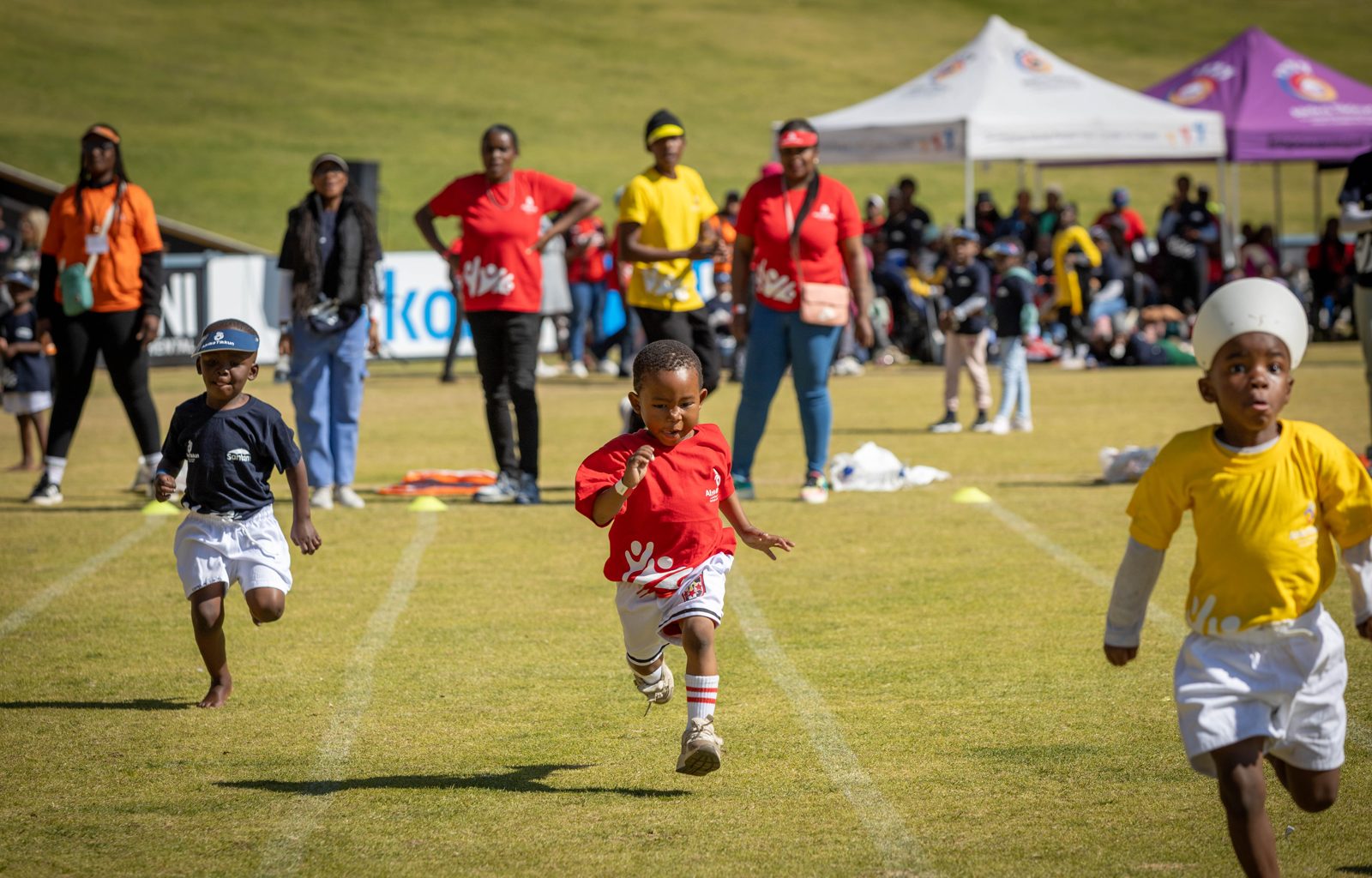Children running a race on a sports field